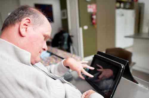 Man with physical disability using a tablet